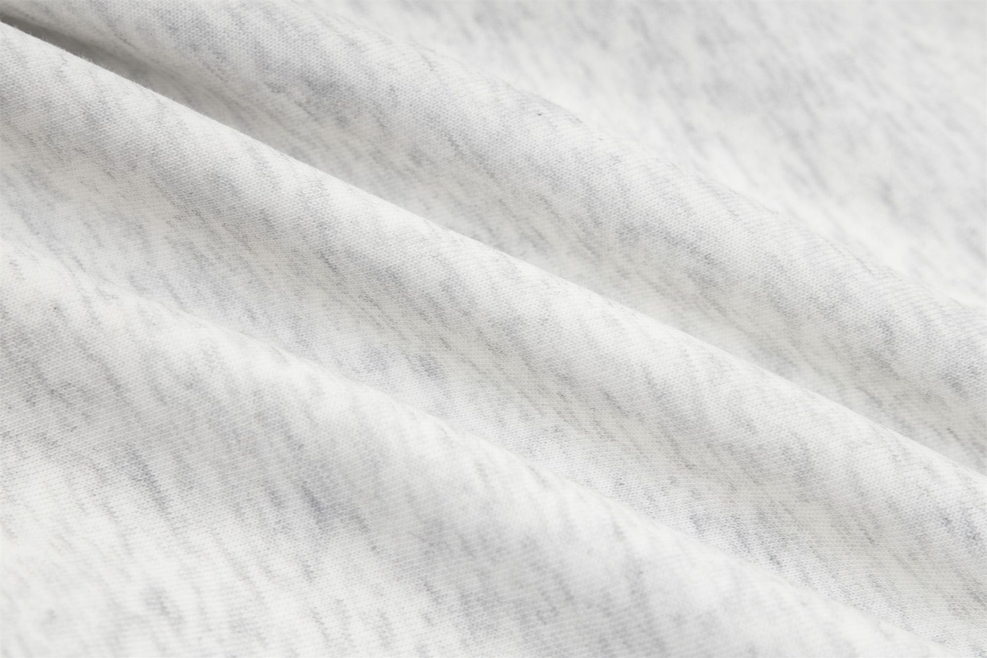 Close-up of soft, breathable fabric showcasing a textured pattern for autumn layering clothing.